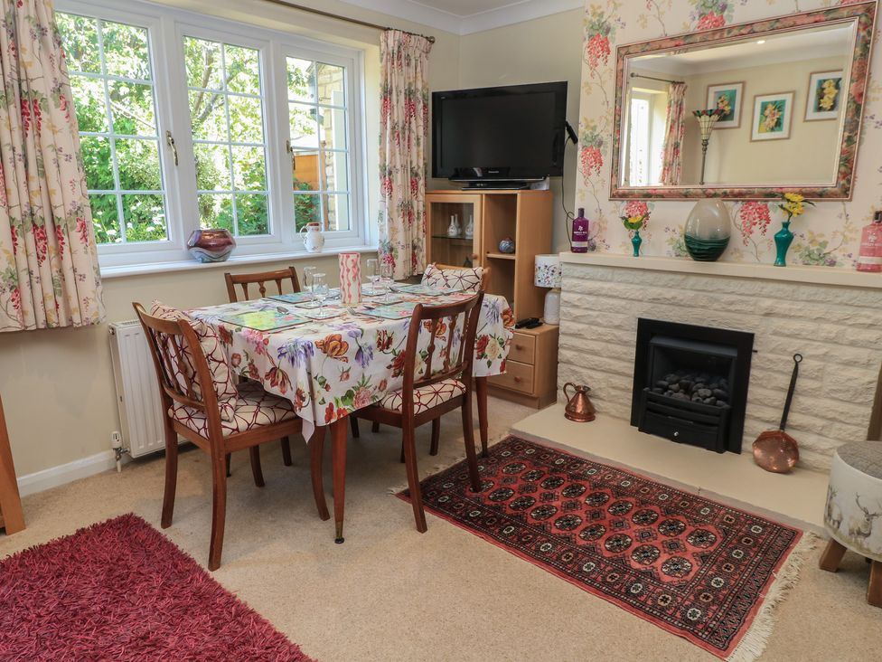 A dining room with a table and chairs at Evergreen in Broadway