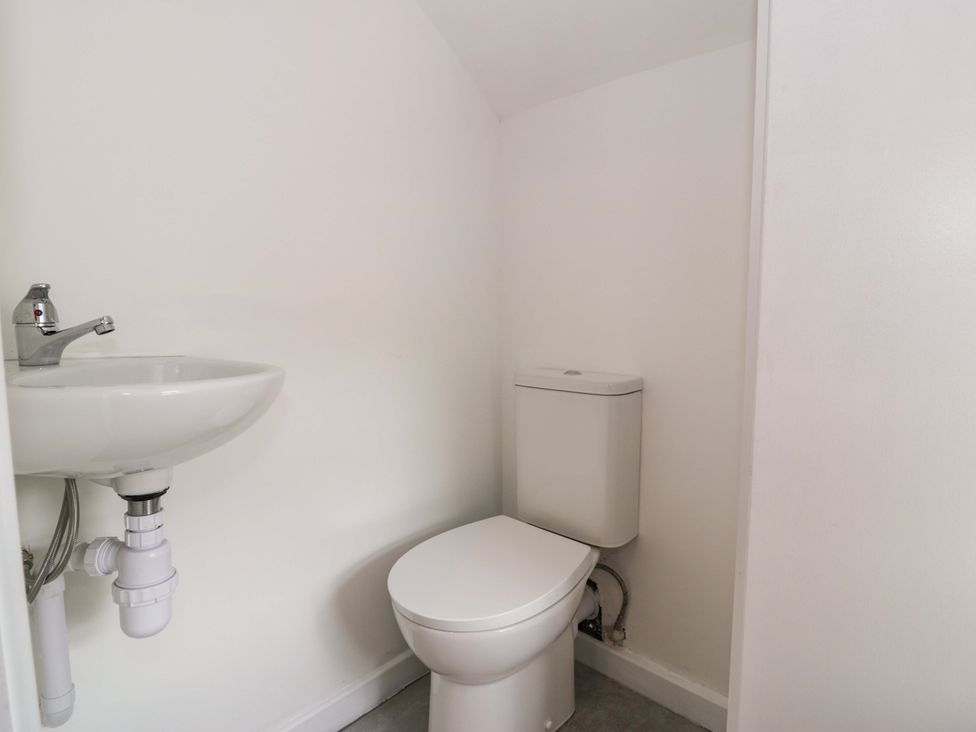 A bathroom with a sink and toilet at Rosemary Cottage 1 Tywyn