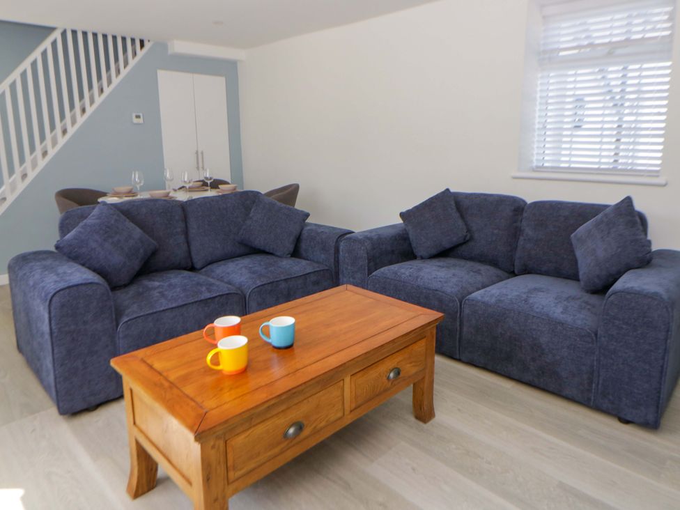 A living room with sofas and a coffee table at Rosemary Cottage 1 in Tywyn