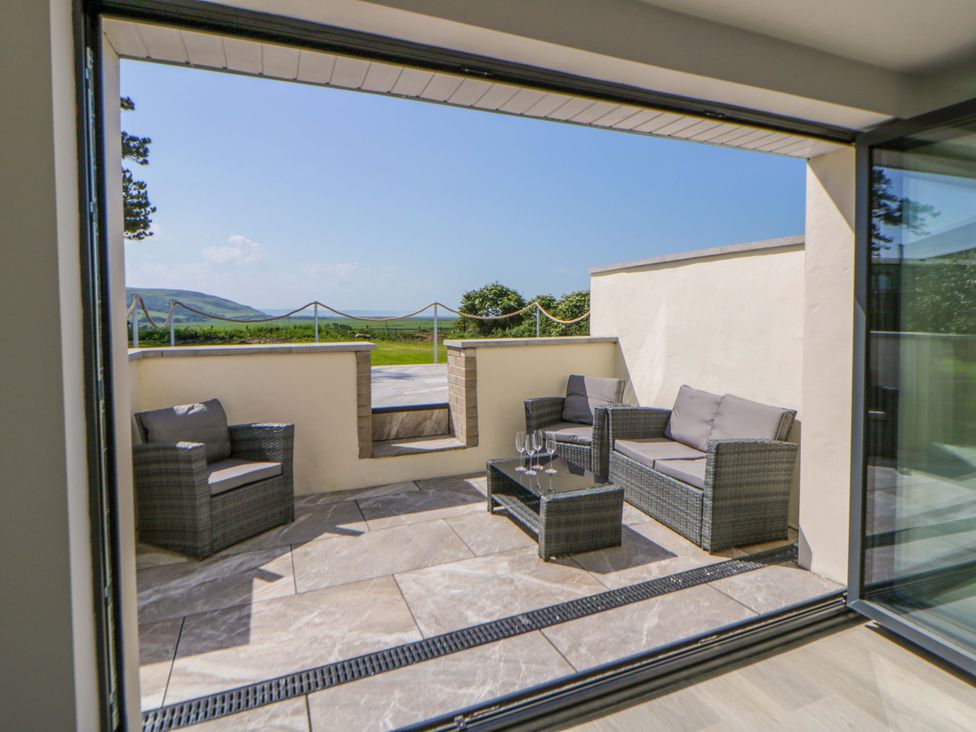 An outdoor area with seating and a view at Rosemary Cottage 1 Tywyn