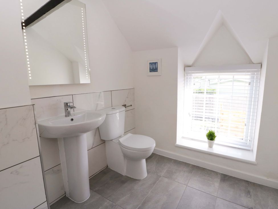 A bathroom with a sink and toilet at Rosemary Cottage 1 Tywyn