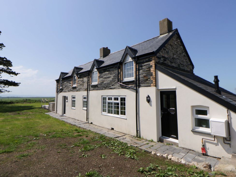 A house exterior with windows and a door at Rosemary Cottage 1 Tywyn
