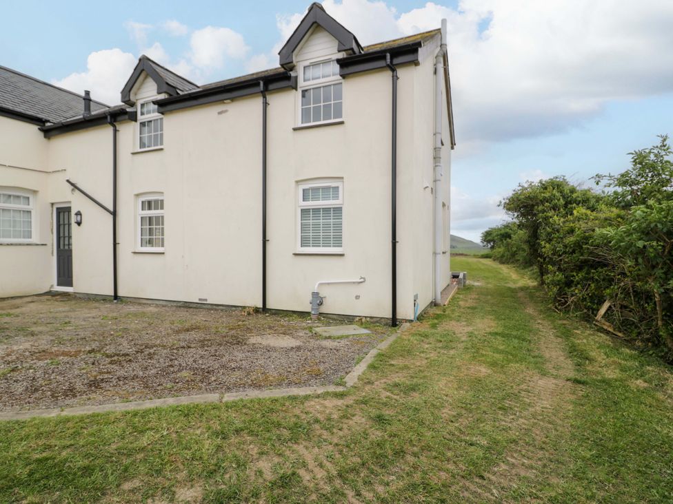 An exterior view of a house with a pathway at Rosemary Cottage 2 in Tywyn