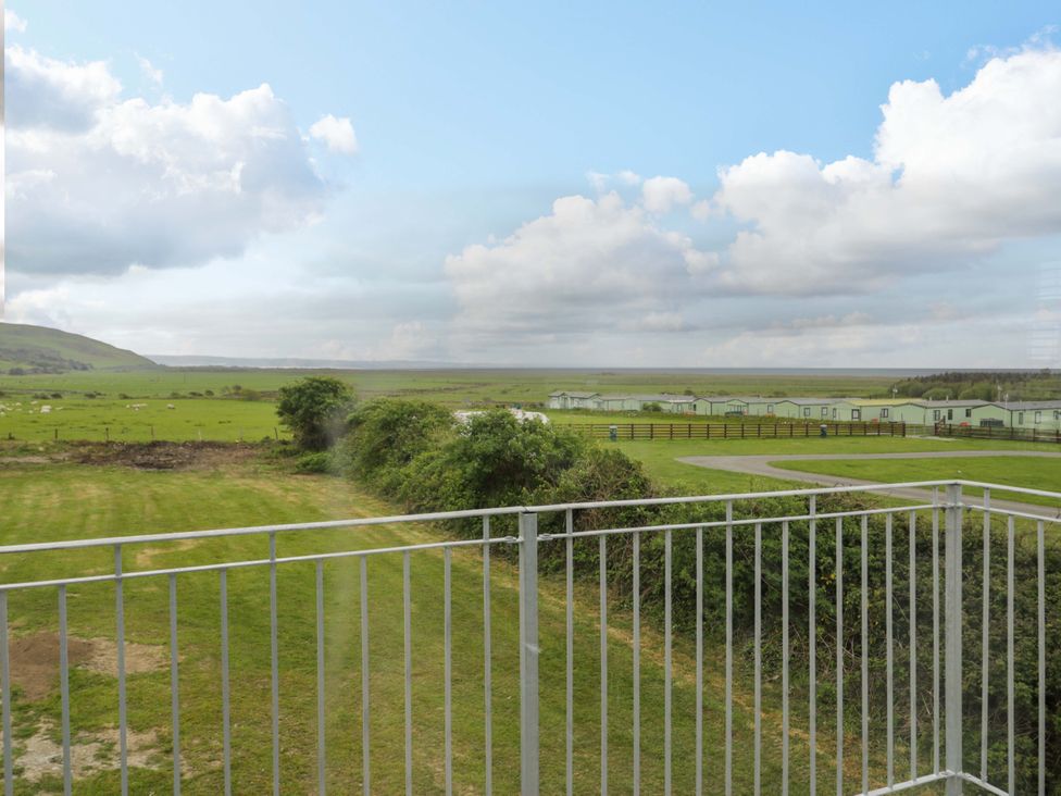 A view of a caravan park and open field at Rosemary Cottage 2 Tywyn