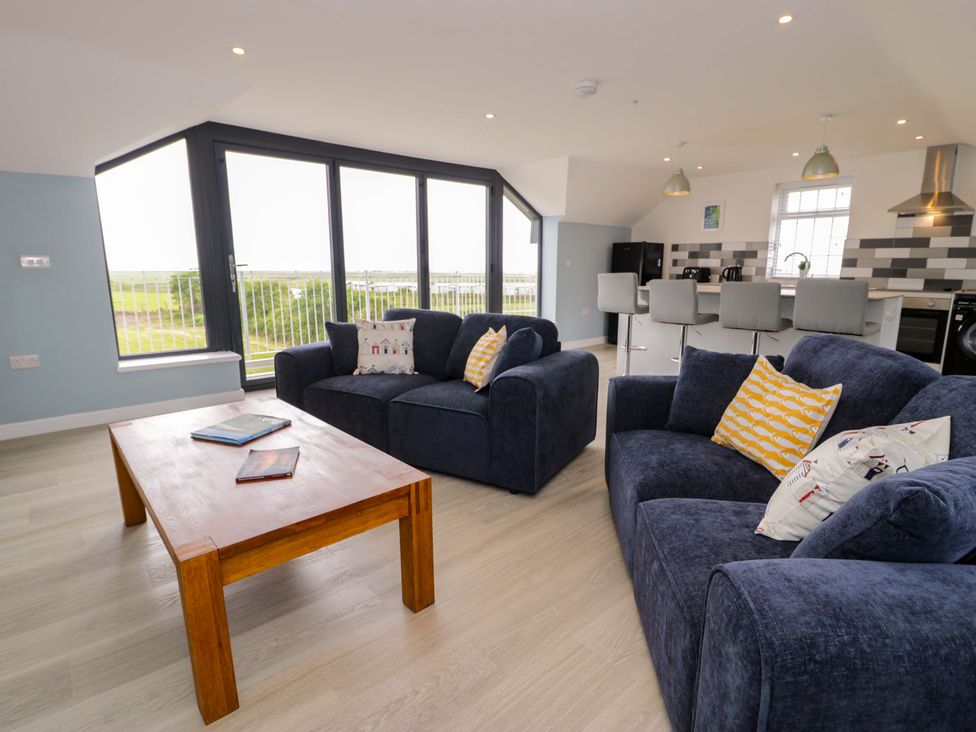 A living room with sofas and a coffee table at Rosemary Cottage 2 in Tywyn