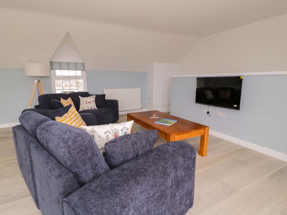 A living room with sofas and a coffee table at Rosemary Cottage 2 in Tywyn
