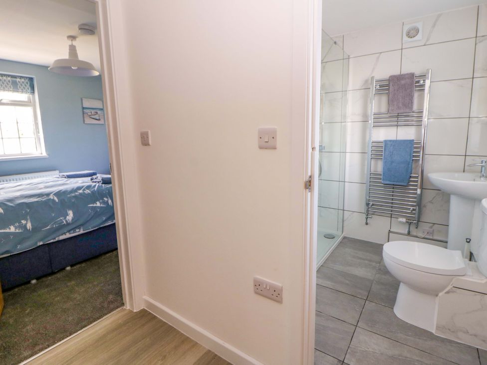 A bathroom with a toilet and sink at Rosemary Cottage 2 Tywyn