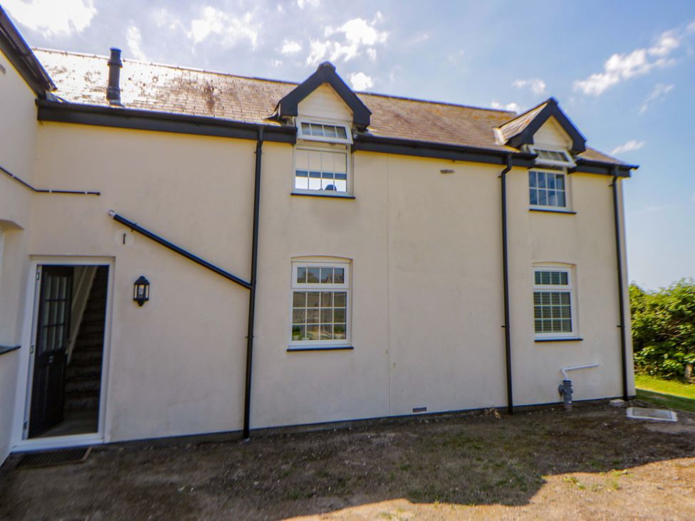 An exterior view of a building with windows and a door at Rosemary Cottage 2 in Tywyn