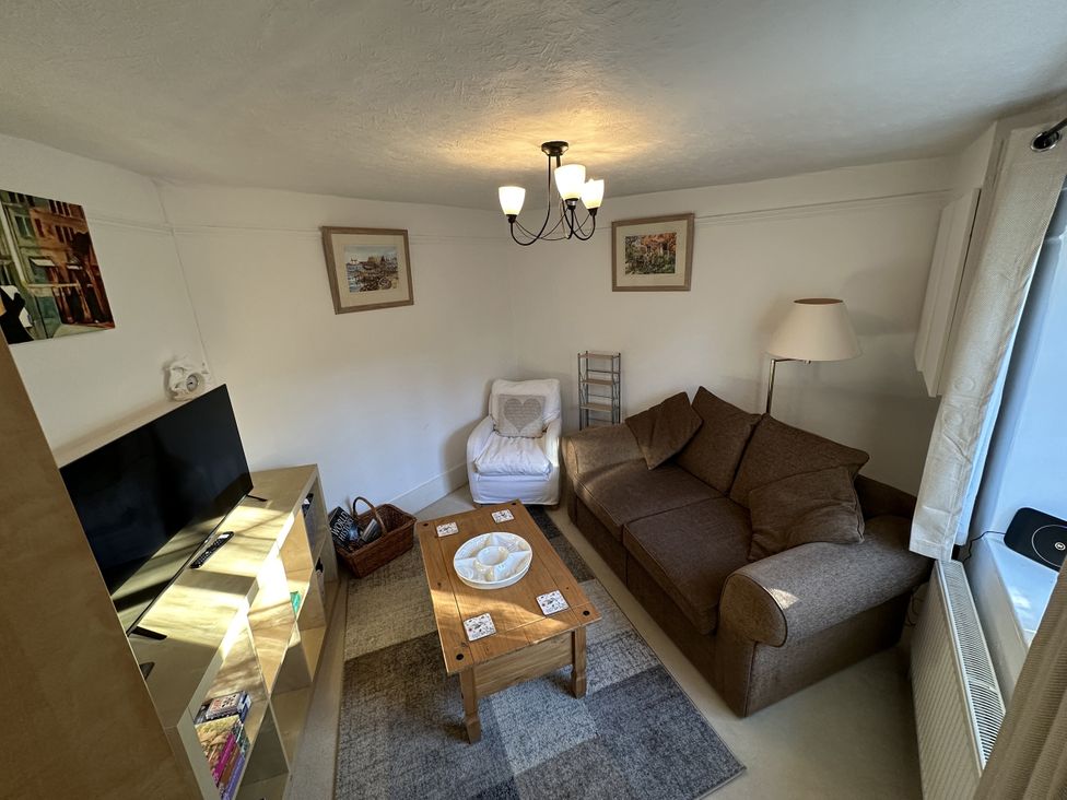 A living room with a sofa and coffee table at Hop Cottage in Buriton