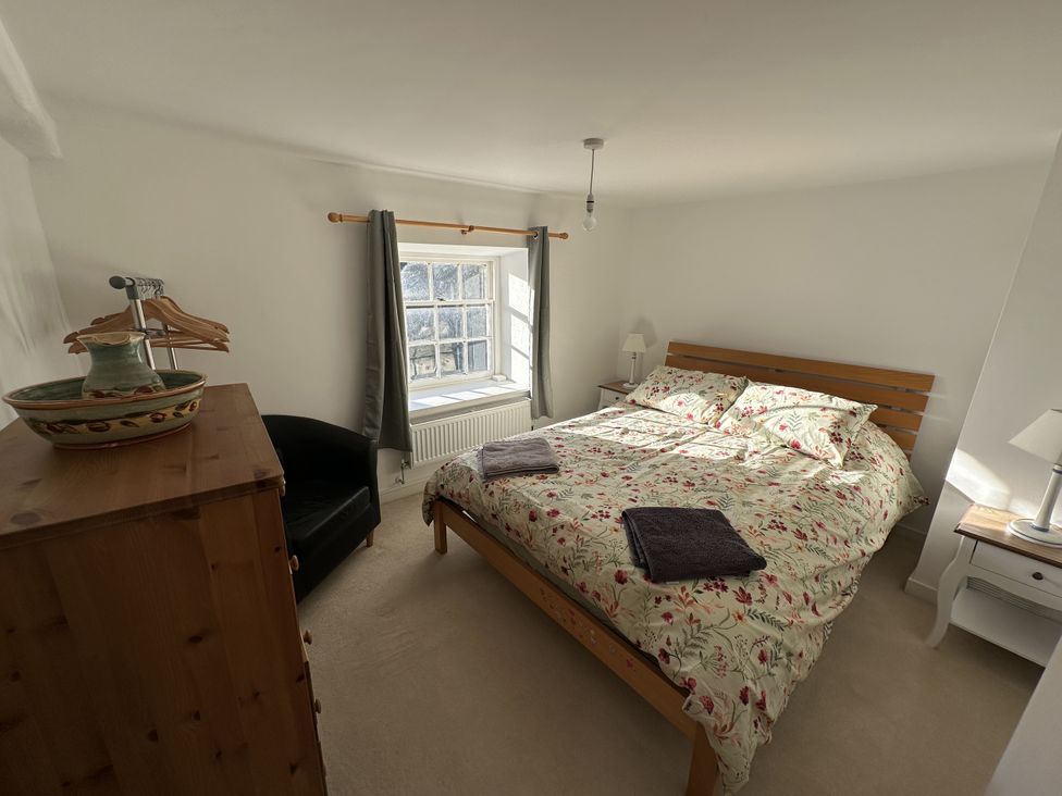 A bedroom with a bed and window at Hop Cottage in Buriton