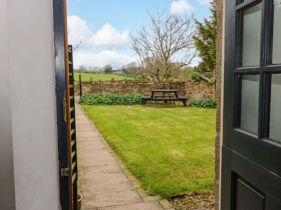 A garden viewed from an open door at The Hay Barn 