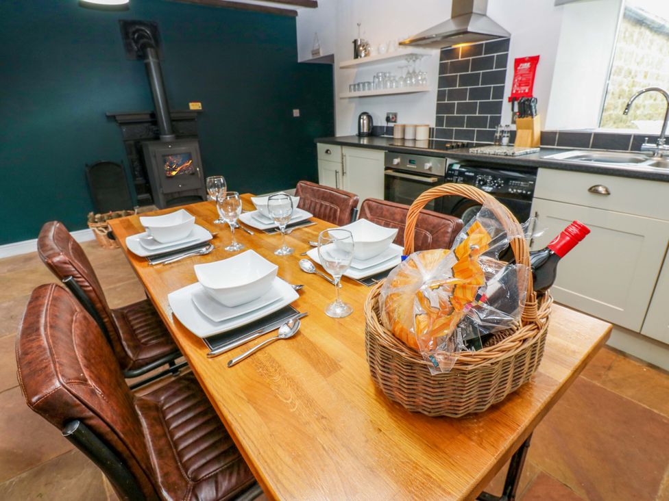 A dining table set with plates and glasses at The Hay Barn in 
