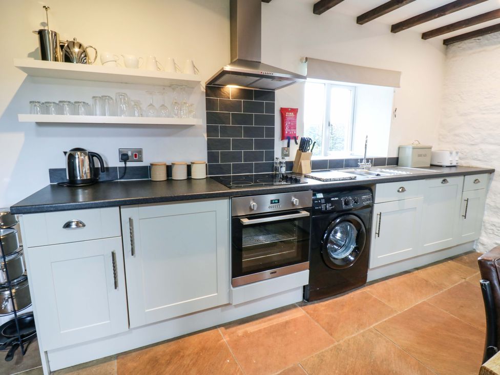 A kitchen with appliances and storage at The Hay Barn in 