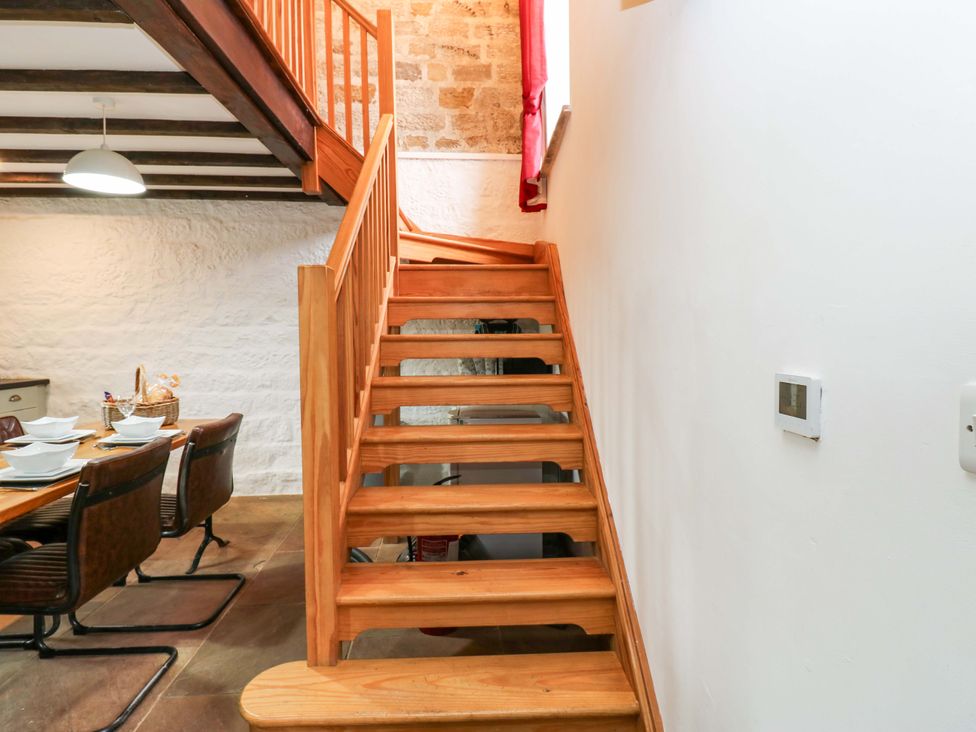 A staircase leads to an upper level in The Hay Barn