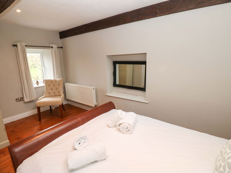 A bedroom with a bed and towels at The Hay Barn 