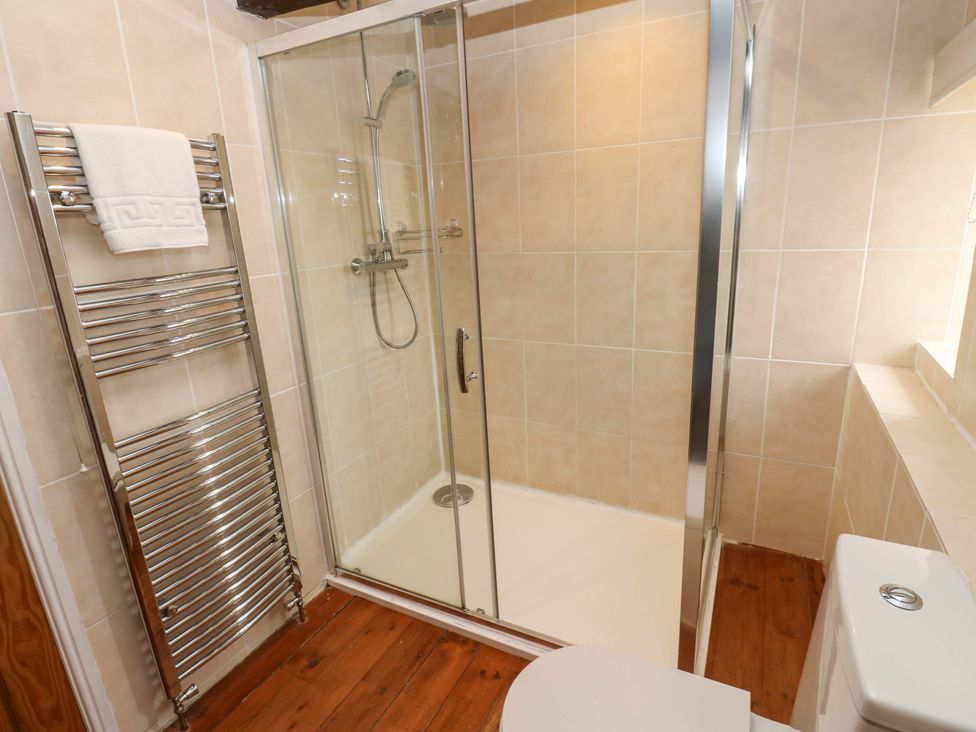 A bathroom with a shower and toilet at The Hay Barn in 