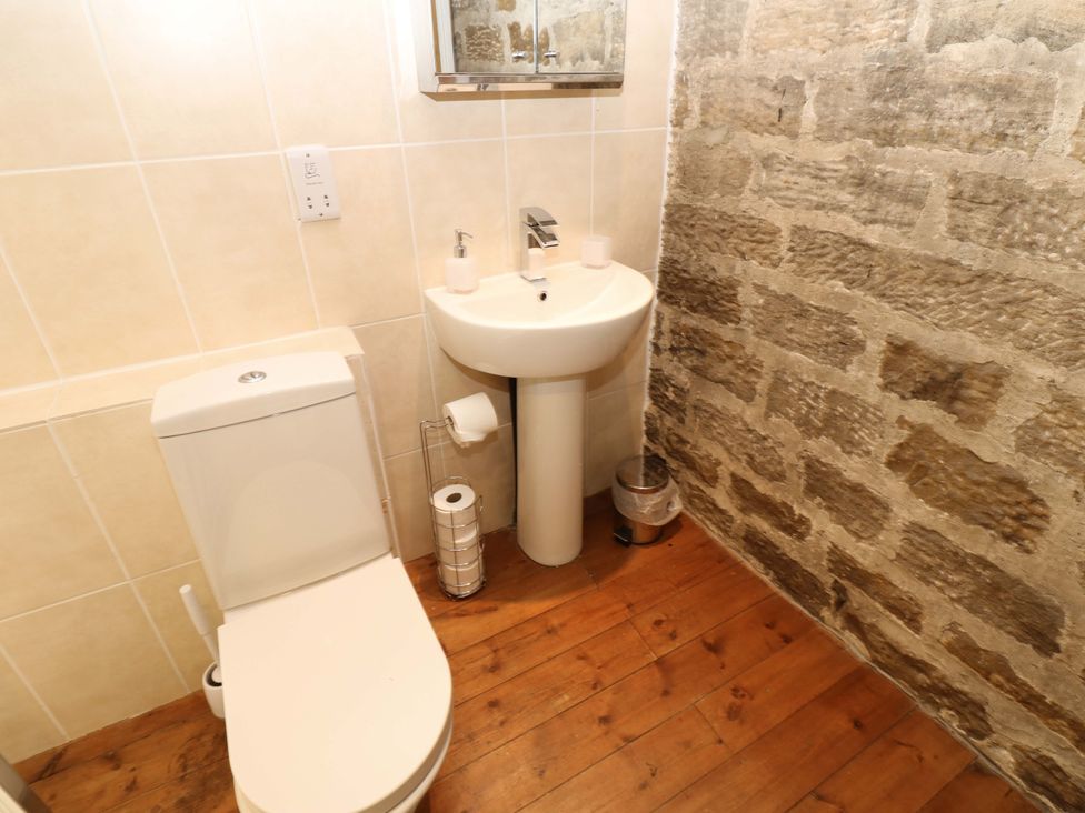 A bathroom with a toilet and sink at The Hay Barn 