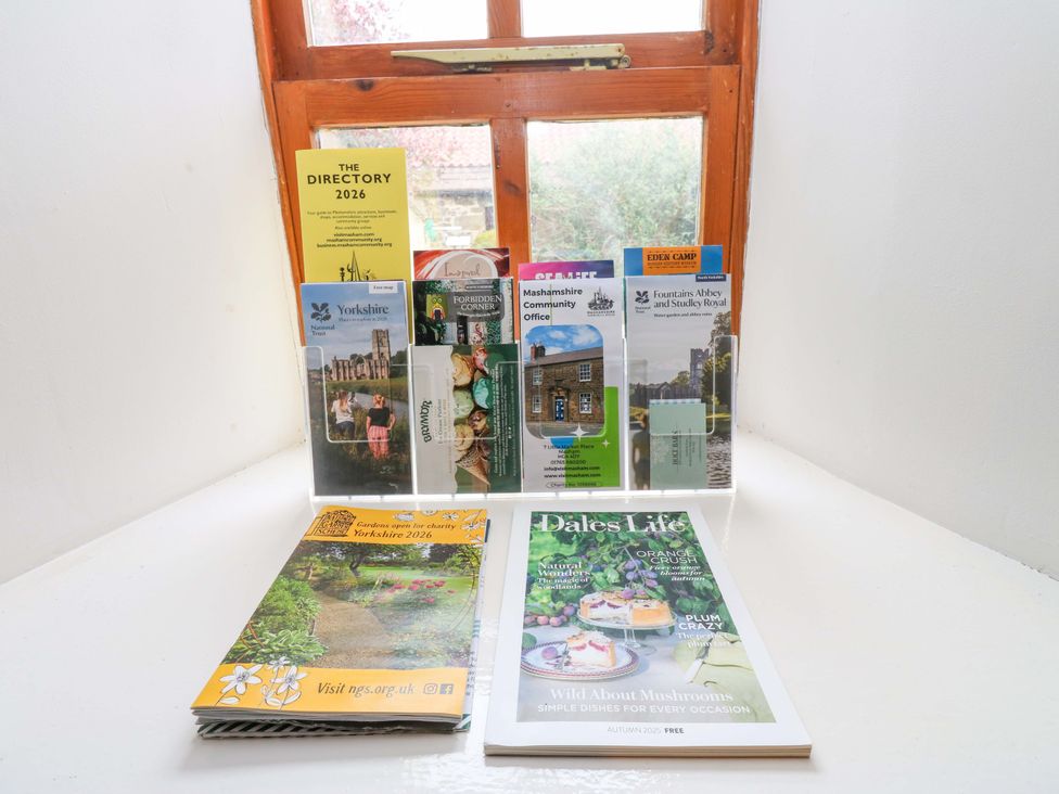 A display of brochures and magazines on a table near a window at The Hay Barn 