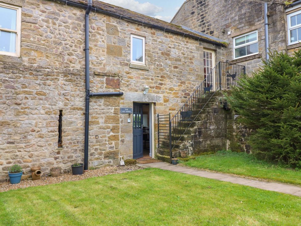 An outdoor view of a stone building with stairs at The Hay Barn 
