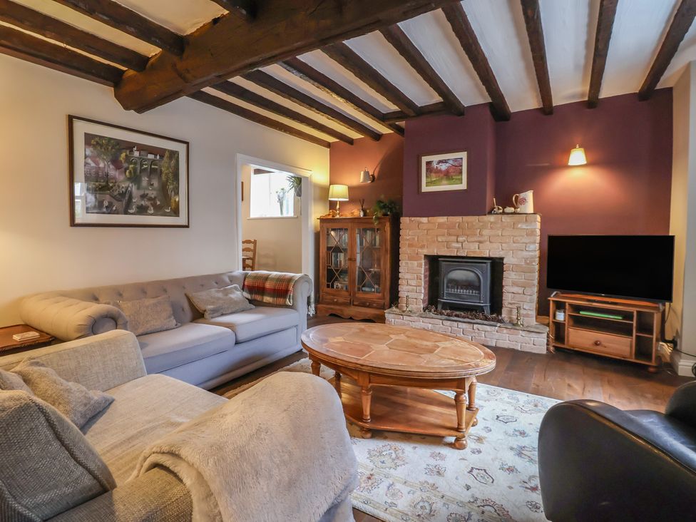 A living room with furniture and a fireplace at Maple Tree Cottage in Knaresborough