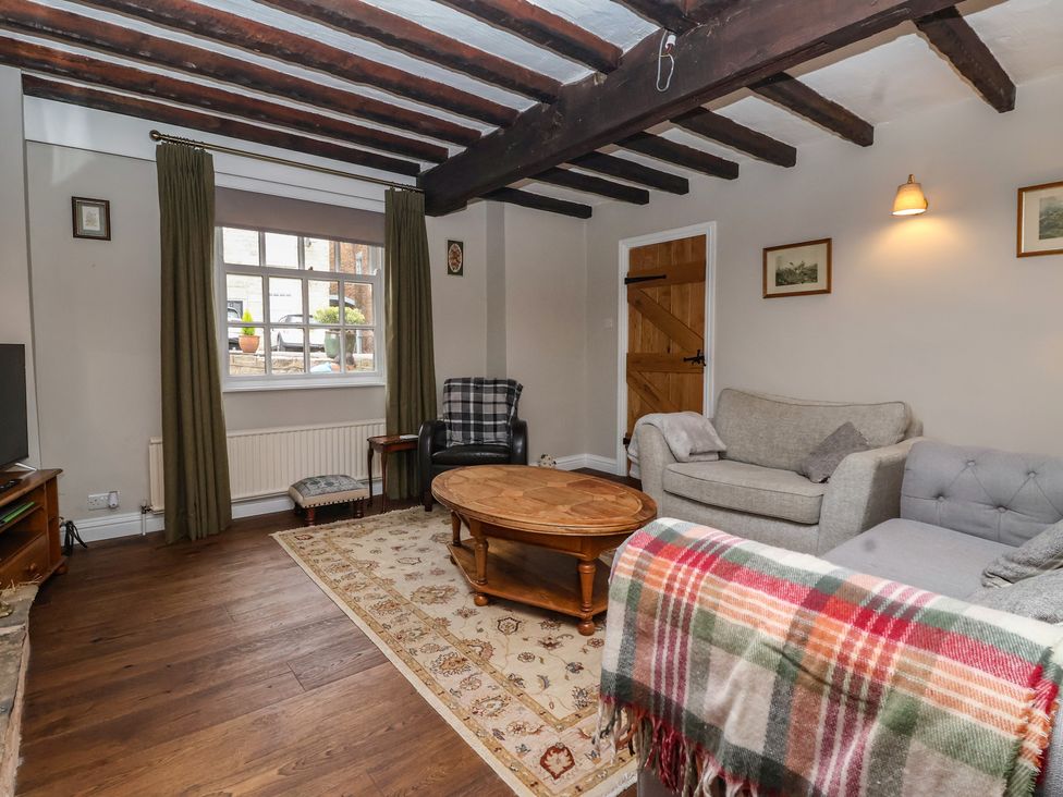 A living room with a coffee table and armchairs at Maple Tree Cottage in Knaresborough