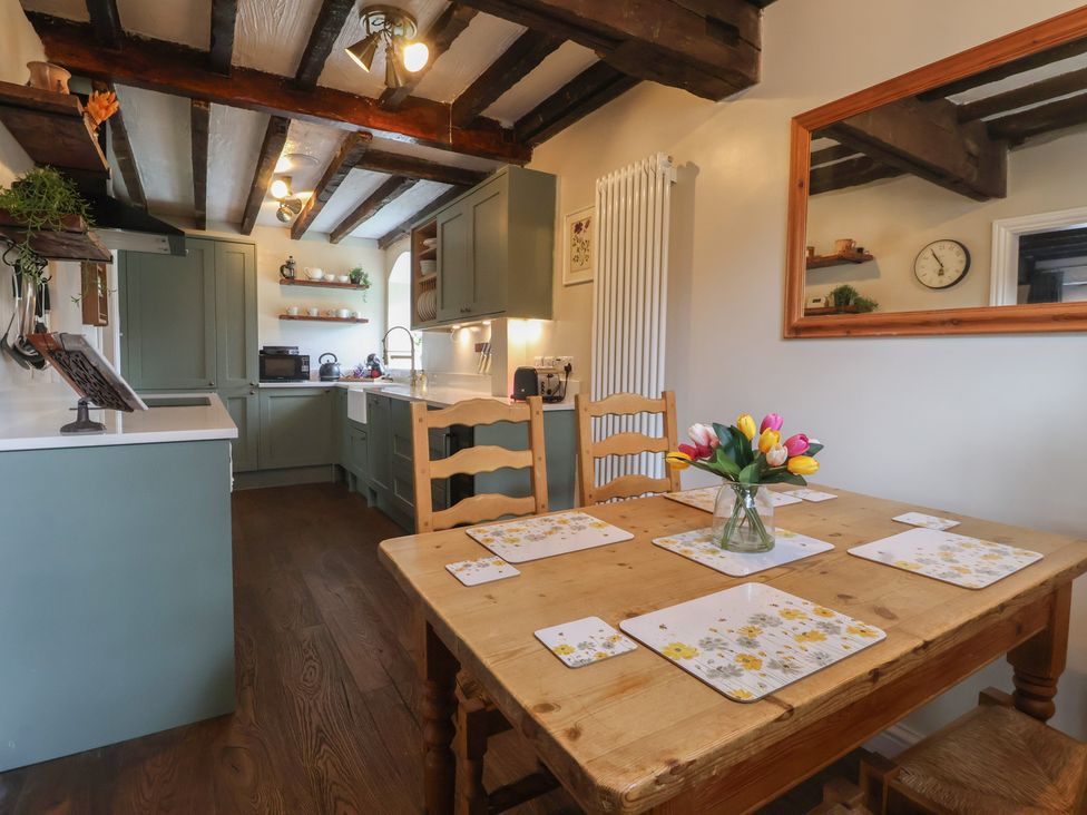 A kitchen with dining table and chairs at Maple Tree Cottage in Knaresborough