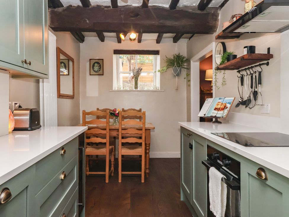 A kitchen with a table and chairs at Maple Tree Cottage in Knaresborough