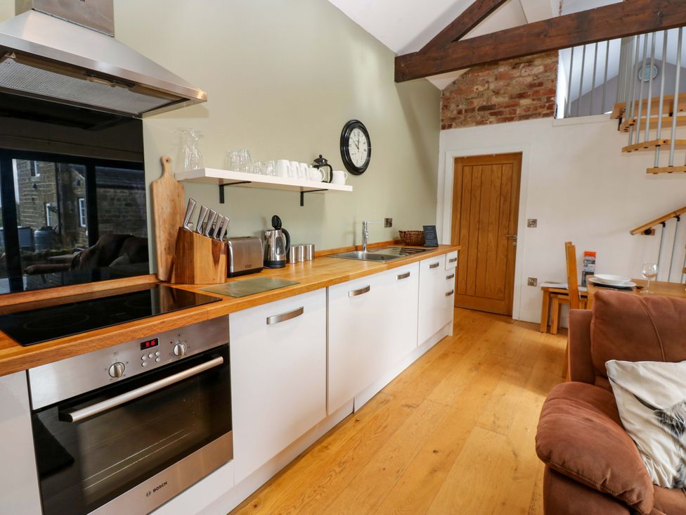 A kitchen with wooden countertop and appliances at The Warren Barn in Kirkby Malzeard