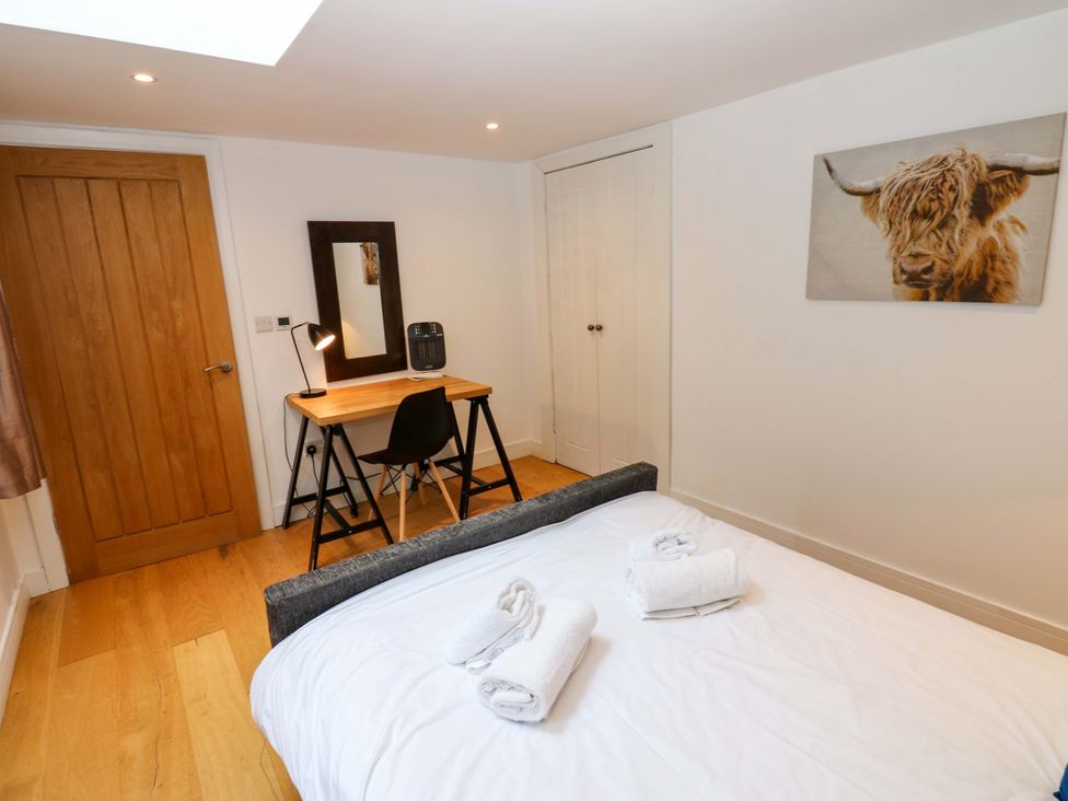 A bedroom with a bed and desk in The Warren Barn in Kirkby Malzeard
