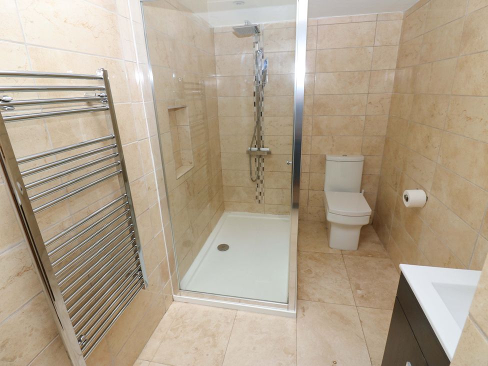 A bathroom with a shower and toilet at The Warren Barn in Kirkby Malzeard