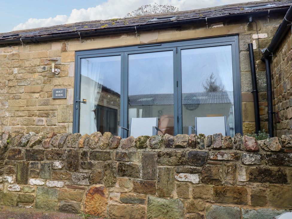 Exterior view of Holt Barn with a stone wall at The Holt Barn in Kirkby Malzeard