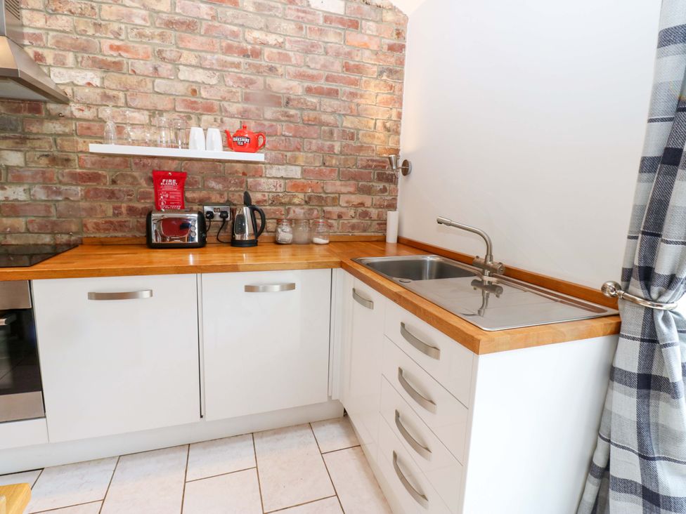 A kitchen with a sink and countertop at The Holt Barn in Kirkby Malzeard