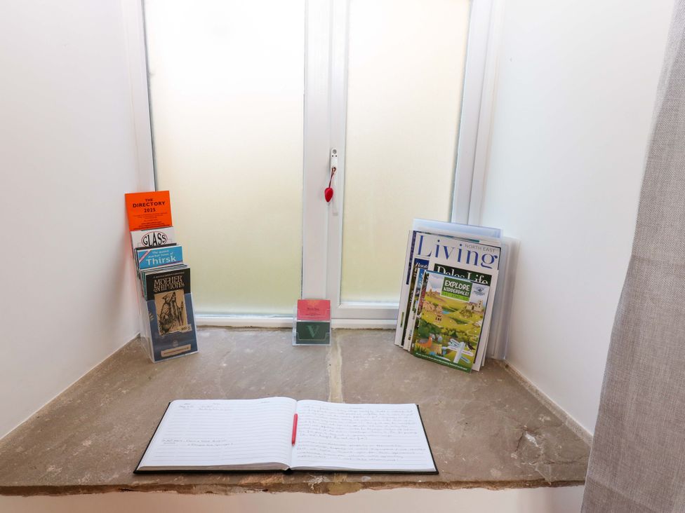 A window with books and a notebook at The Holt Barn in Kirkby Malzeard