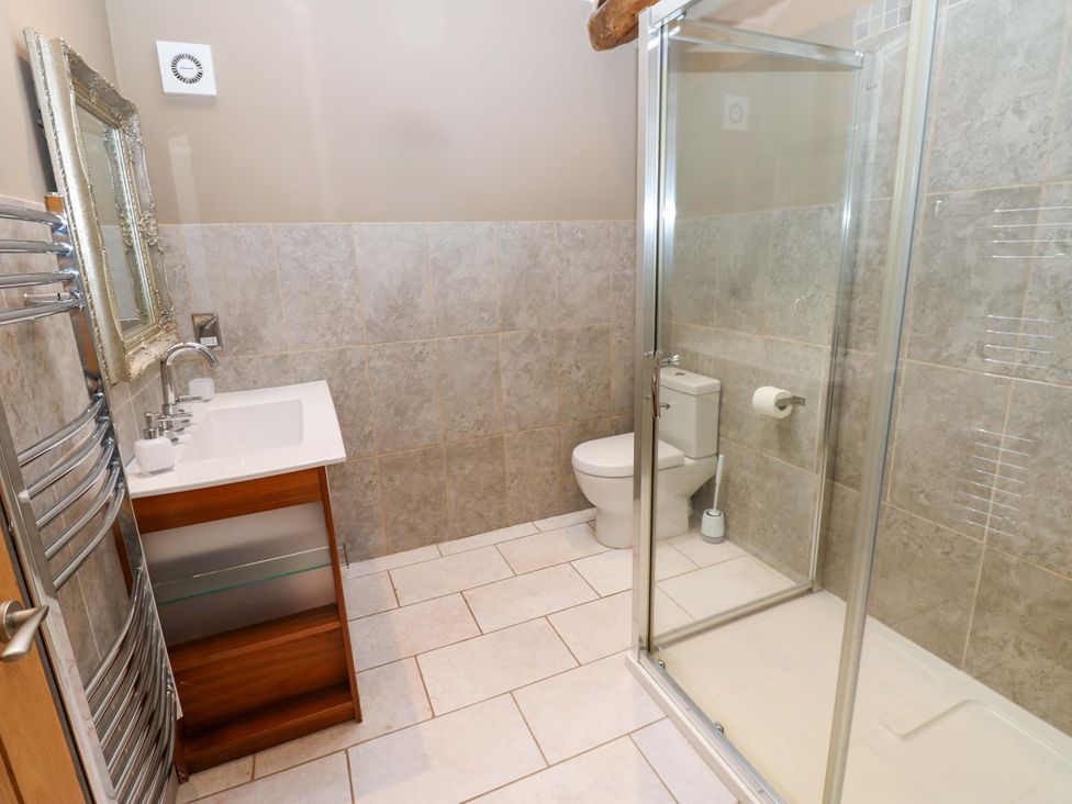 A bathroom featuring a sink, toilet, shower, and towel radiator at The Holt Barn in Kirkby Malzeard