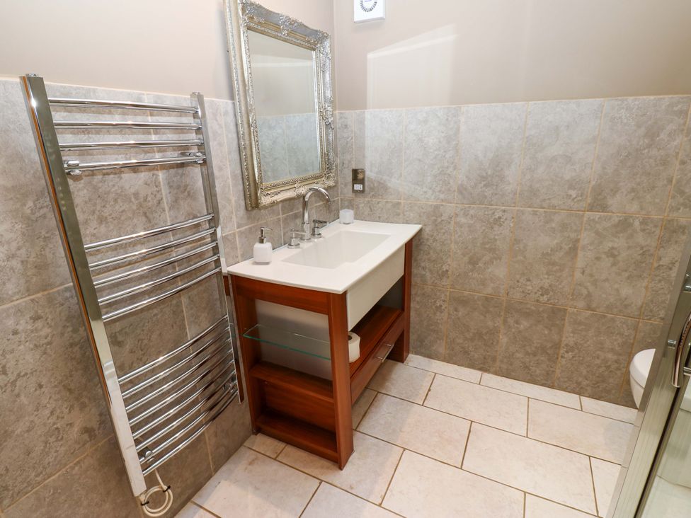 A bathroom with a sink and mirror at The Holt Barn in Kirkby Malzeard