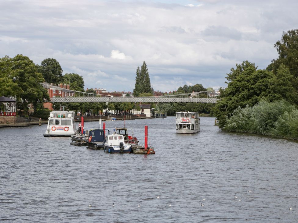 A view of boats on a river under a bridge at Central Vista Retreat Chester