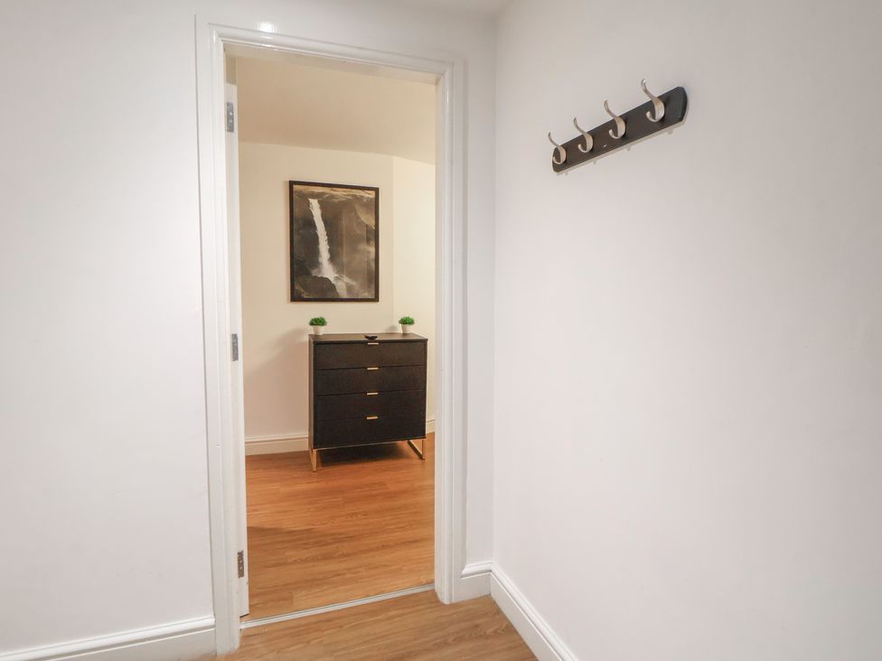 A hallway with a dresser and coat rack at Central Vista Retreat in Chester