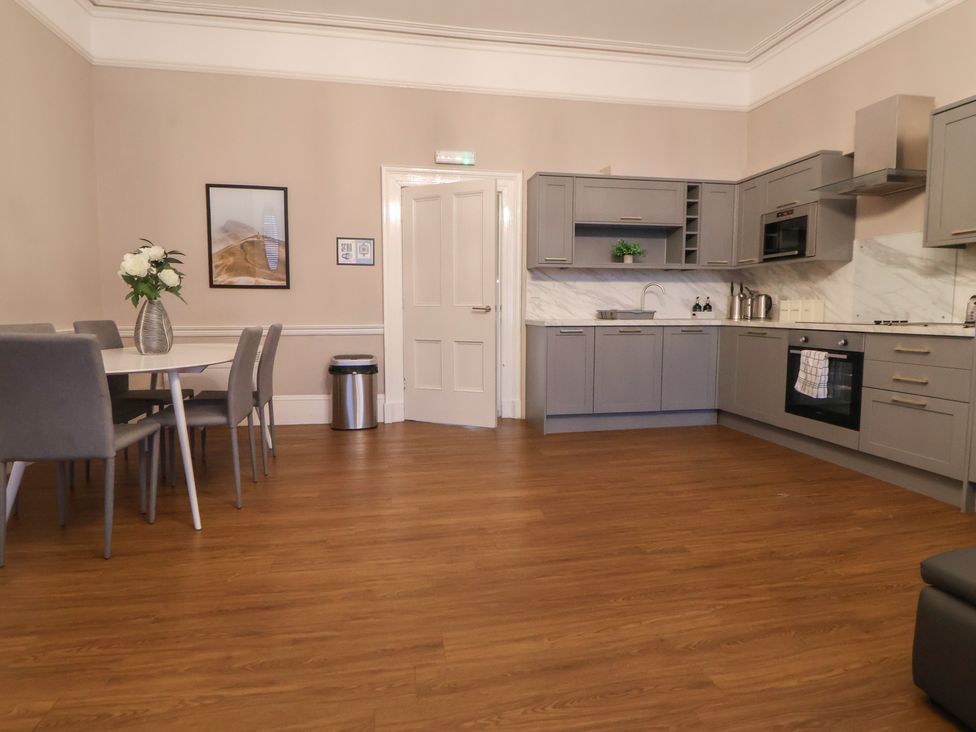 A kitchen with a dining table and gray cabinets at Central Vista Retreat in Chester