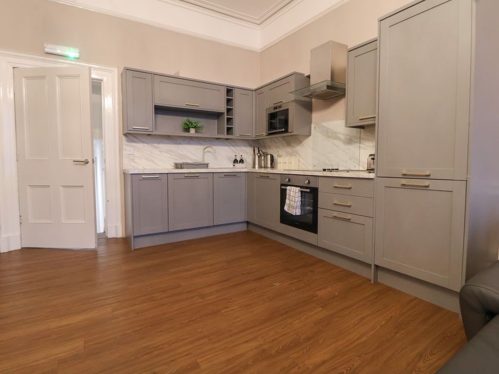 A kitchen with grey cabinets and appliances at Central Vista Retreat in Chester