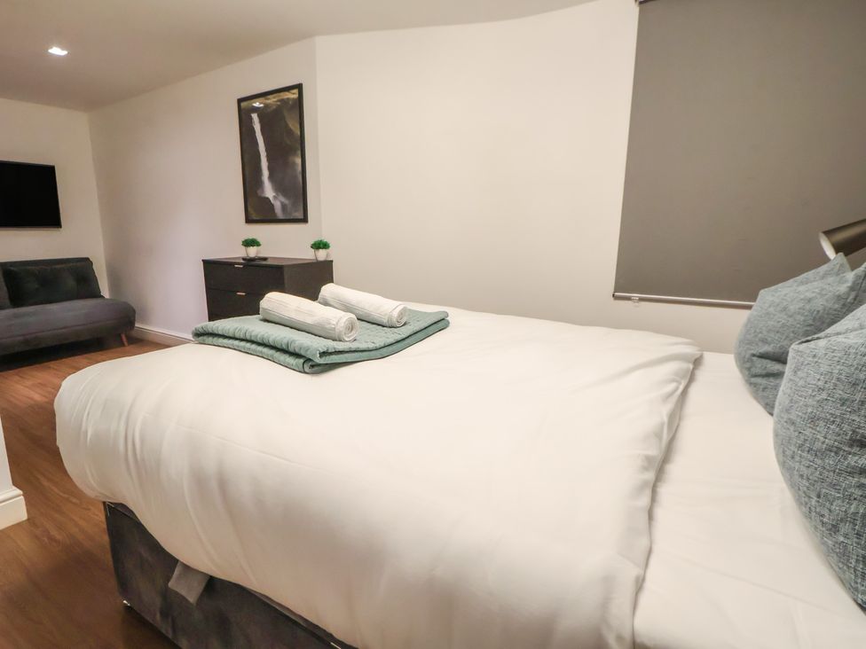 A bedroom with a bed and towels on top at Central Vista Retreat Chester