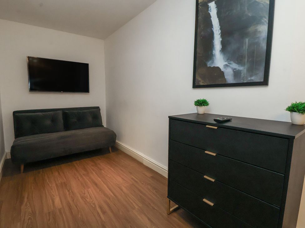 A living room with a sofa and television at Central Vista Retreat in Chester
