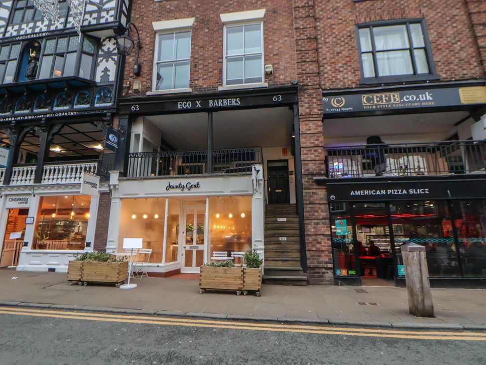 An outdoor view of shops including a barber shop and café at Central Vista Retreat in Chester