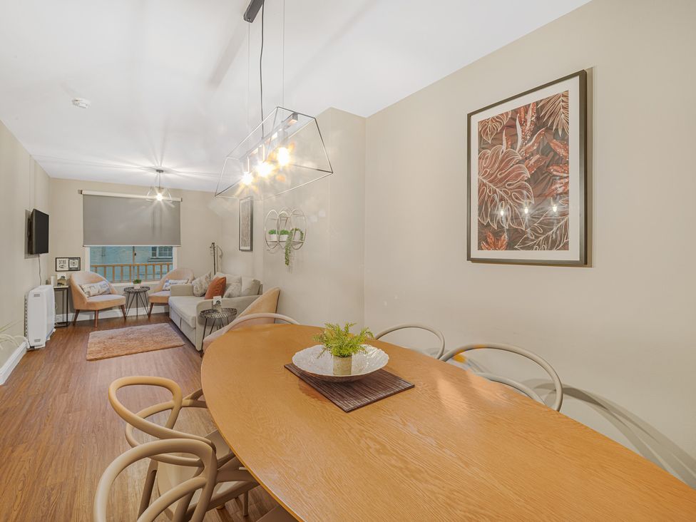 A dining room with a table and chairs at Ravenswood Penthouse in Chester