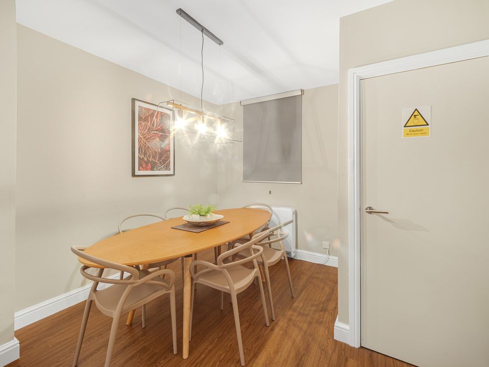A dining room with a table and chairs at Ravenswood Penthouse in Chester