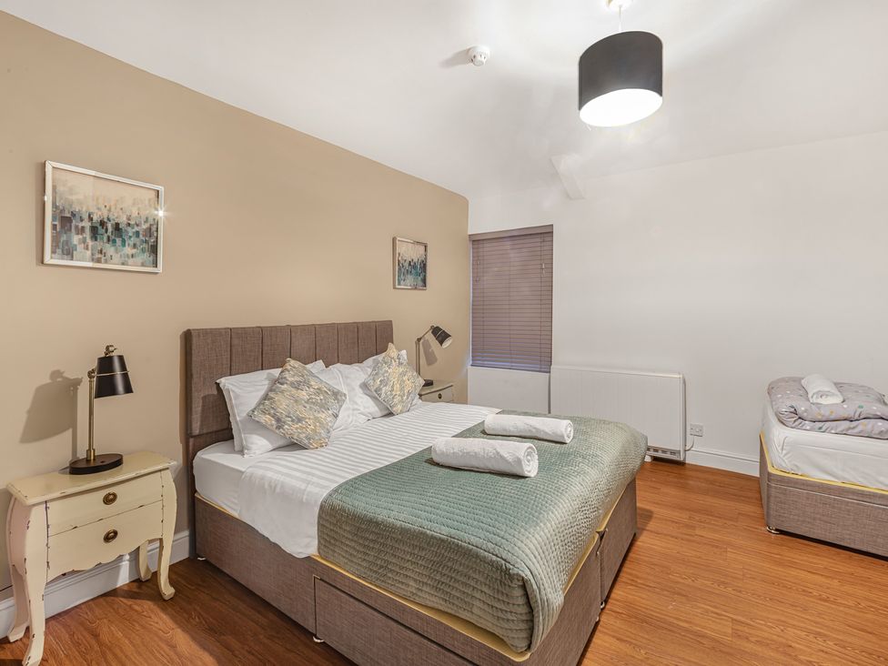 A bedroom with a bed and bedside table at Ravenswood Penthouse in Chester