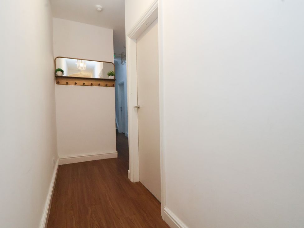 A hallway with a coat rack and mirror at Ravenswood Penthouse Chester