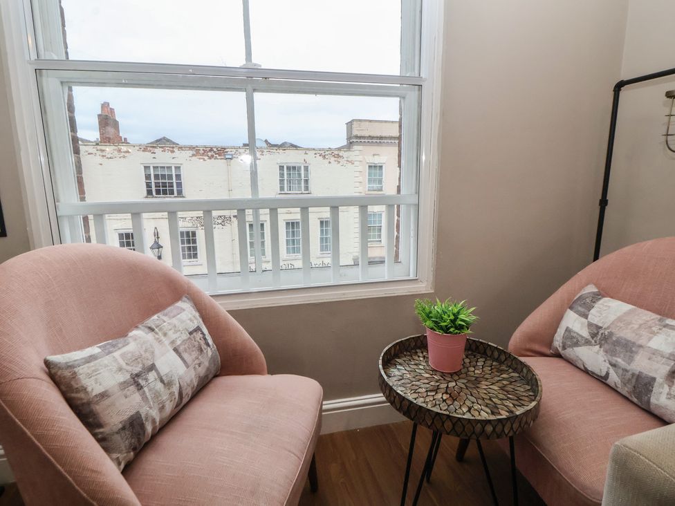 Two chairs and a small table with a plant at Ravenswood Penthouse Chester