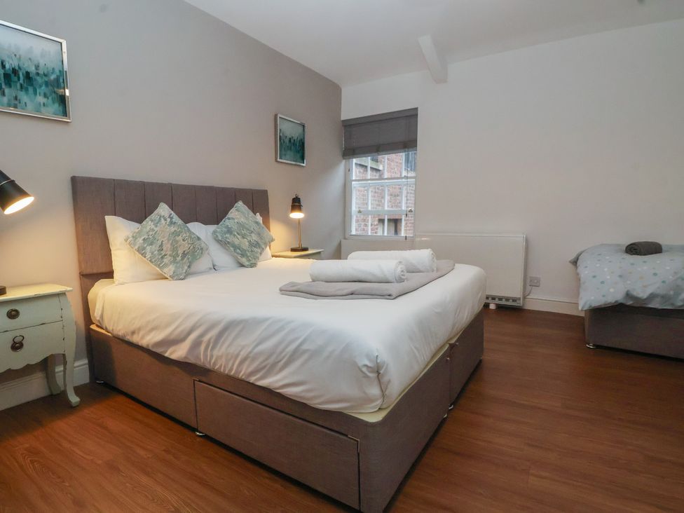 A bedroom with a double bed and bedside table at Ravenswood Penthouse in Chester
