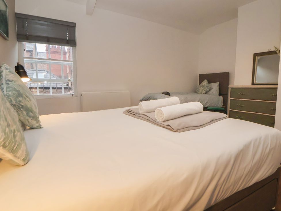 A bedroom with a double bed and twin bed at Ravenswood Penthouse in Chester