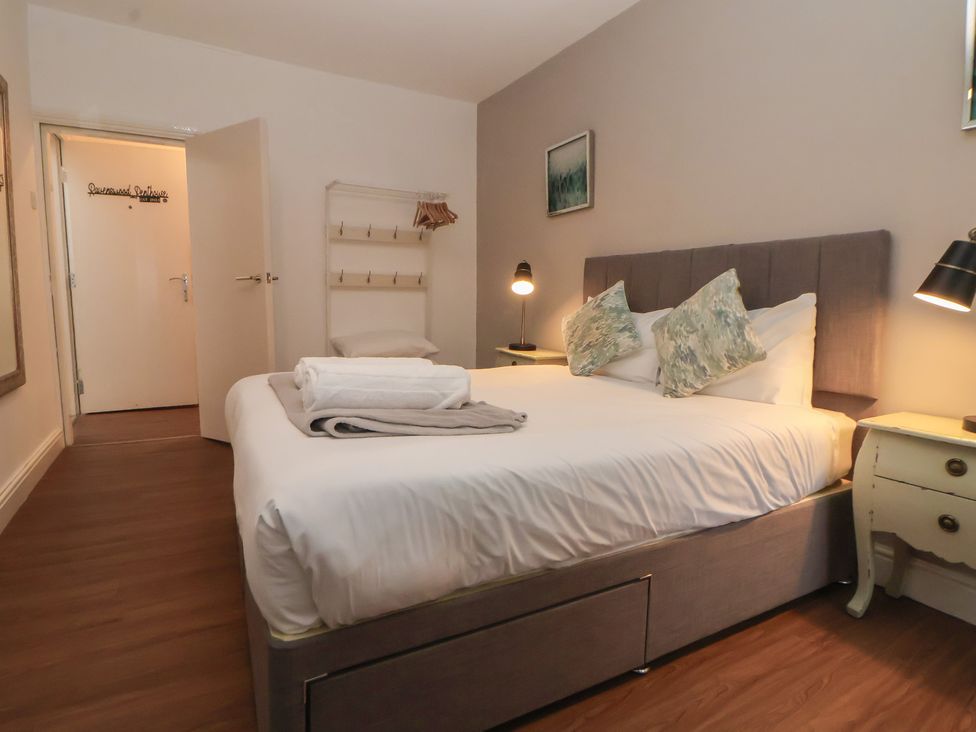 A bedroom with a bed and bedside table at Ravenswood Penthouse Chester